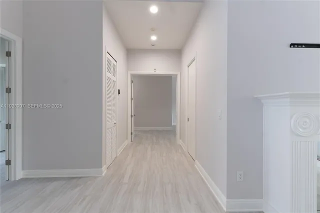 a view of a hallway with wooden floor