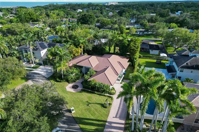 an aerial view of a house with garden space and street view
