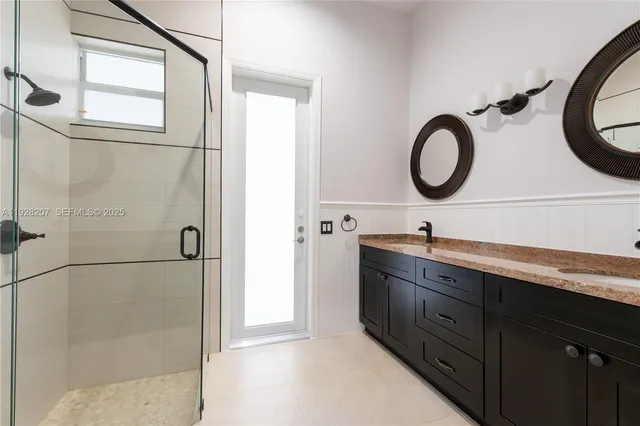a bathroom with a double vanity sink and mirror