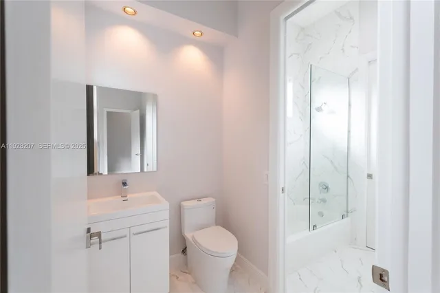 a bathroom with a toilet sink and shower