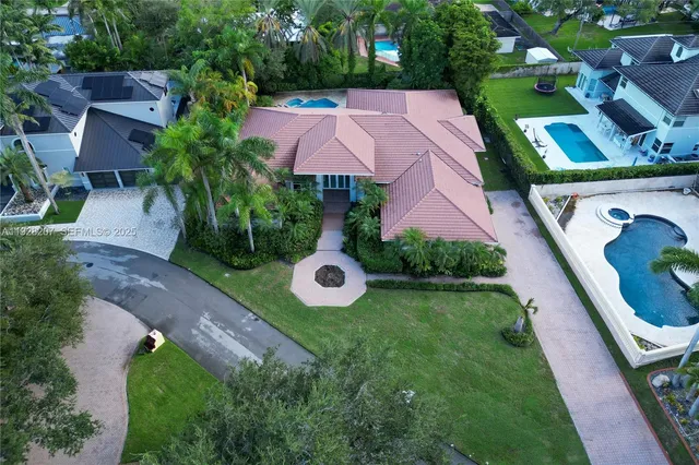 an aerial view of multiple houses with yard