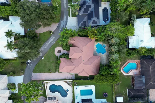 an aerial view of house with a yard and outdoor seating
