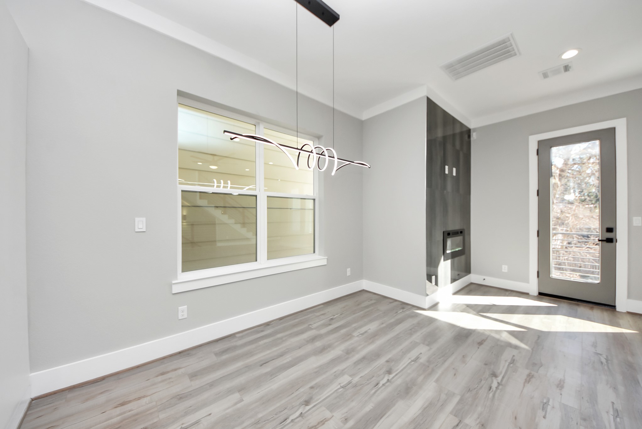 602 West 28th Street, Unit A Houston, TX 77008 - Photo 11 of 41 an empty room with wooden floor and windows