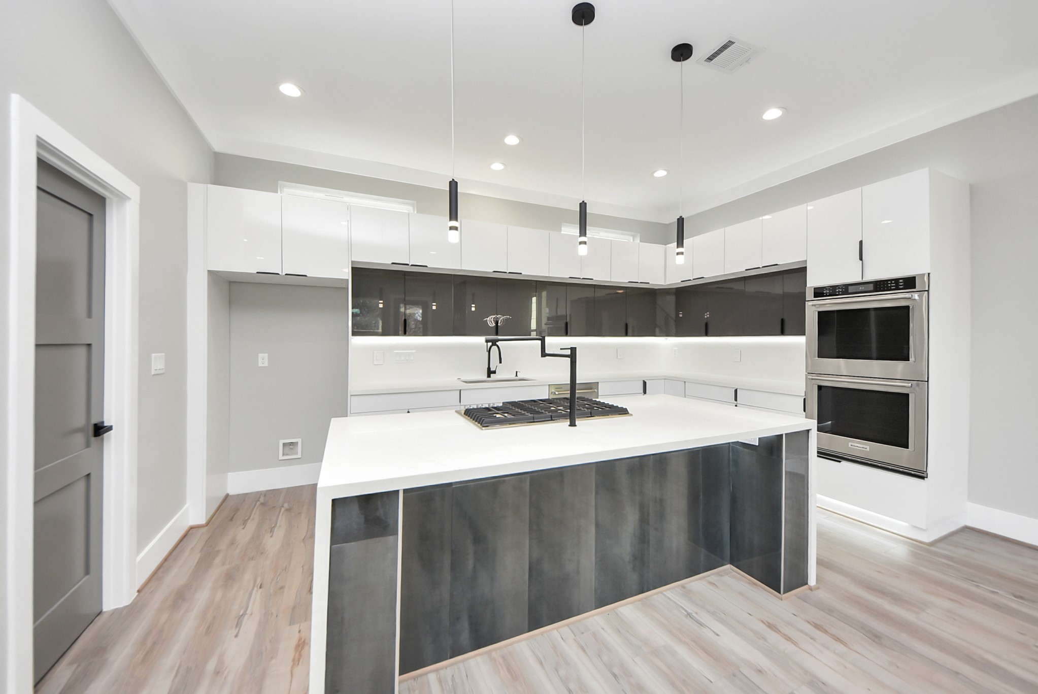 602 West 28th Street, Unit A Houston, TX 77008 - Photo 16 of 41 a kitchen with kitchen island a sink stainless steel appliances and cabinets
