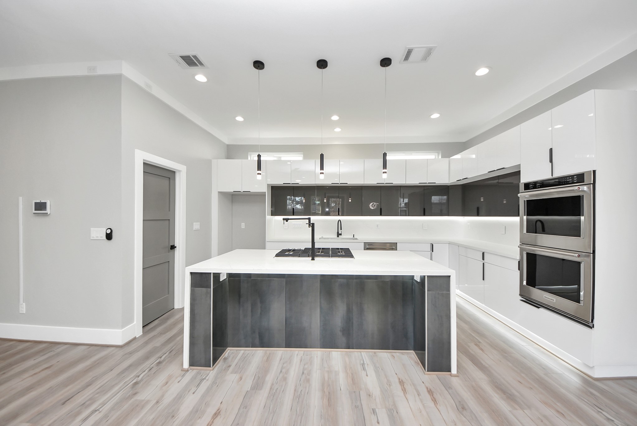 602 West 28th Street, Unit A Houston, TX 77008 - Photo 17 of 41 a kitchen with kitchen island stainless steel appliances a sink stove and cabinets