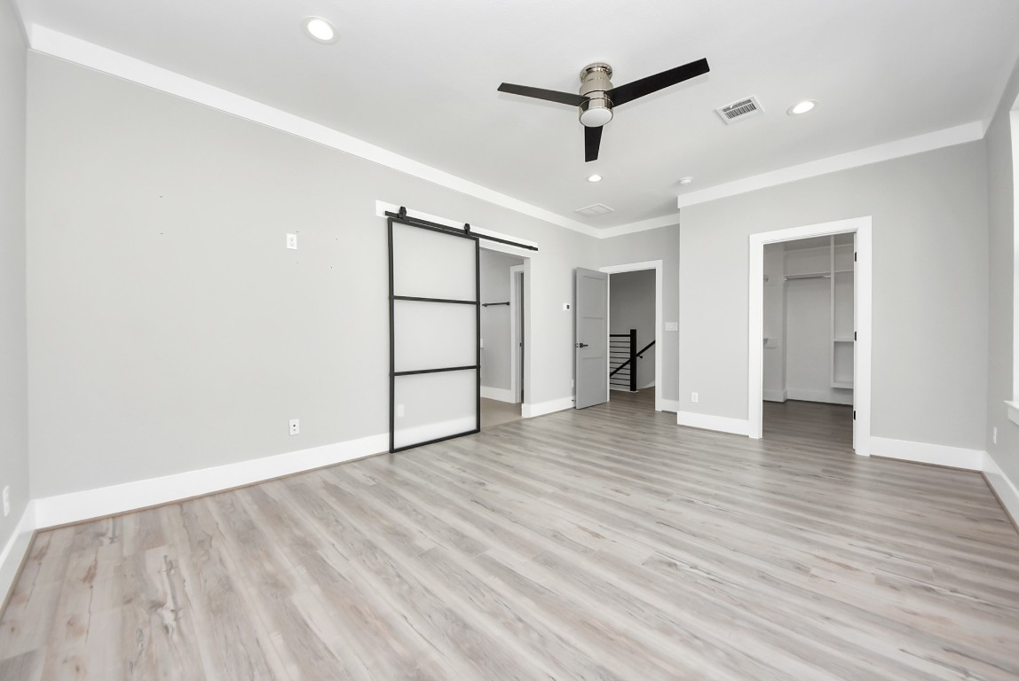 602 West 28th Street, Unit A Houston, TX 77008 - Photo 22 of 41 wooden floor in an empty room with a window