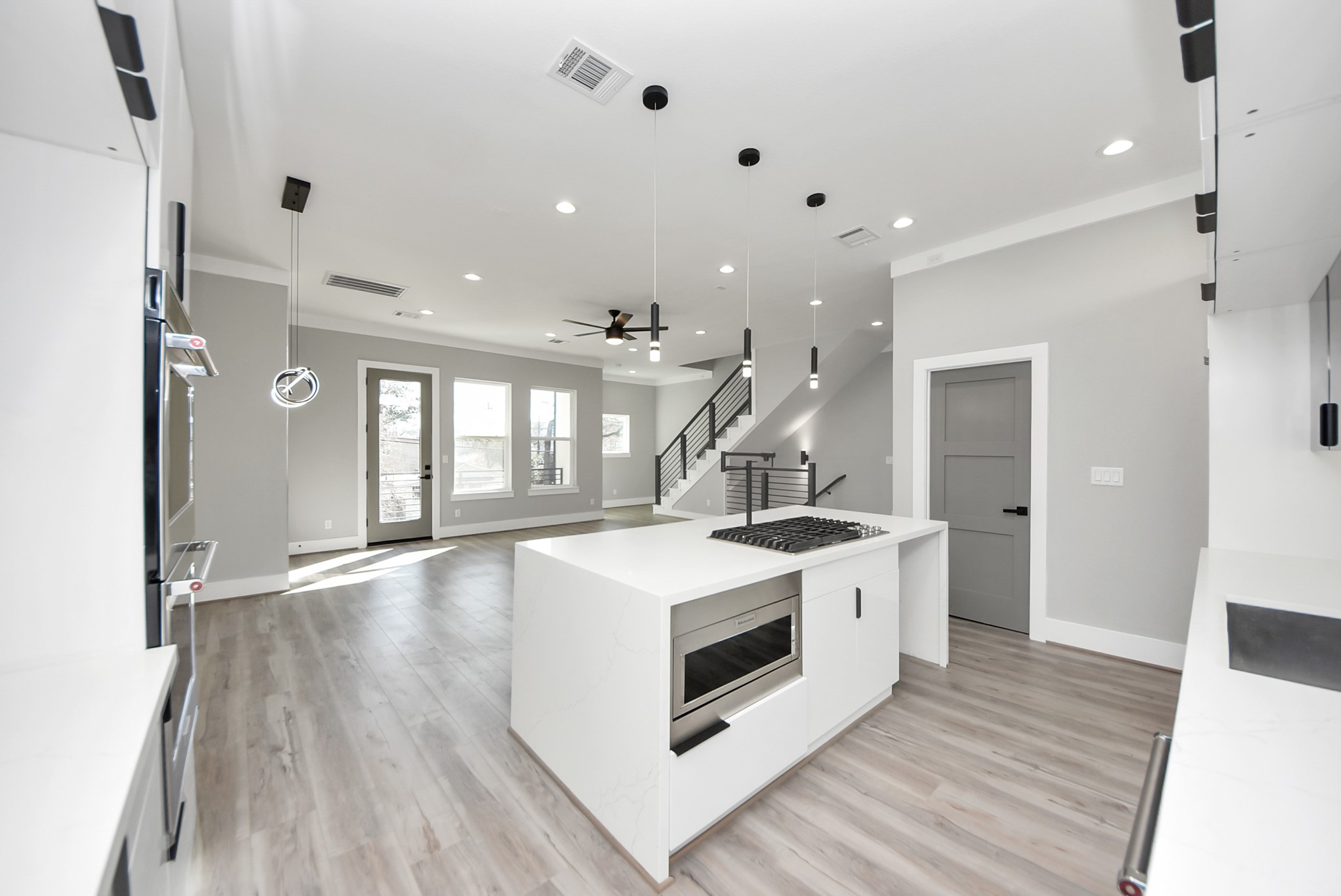 602 West 28th Street, Unit A Houston, TX 77008 - Photo 7 of 41 a white kitchen with wooden floor and white cabinets