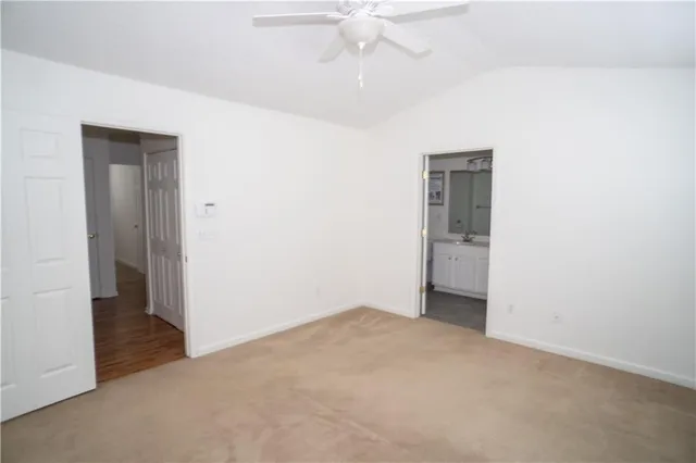 an empty room with fan and entrance