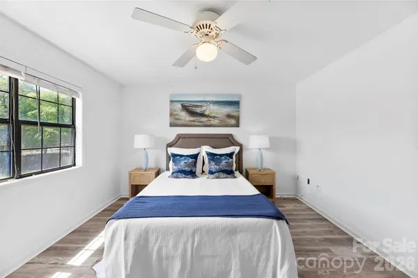 a bedroom with a large bed and a chandelier