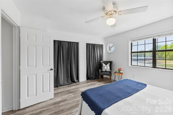 a bedroom with a bed dresser and a window