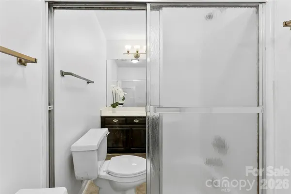 a bathroom with a toilet and a shower