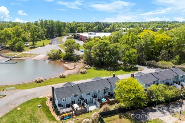 an aerial view of a house with a swimming pool yard and outdoor seating