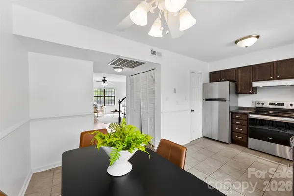 a living room with furniture potted plant and a chandelier