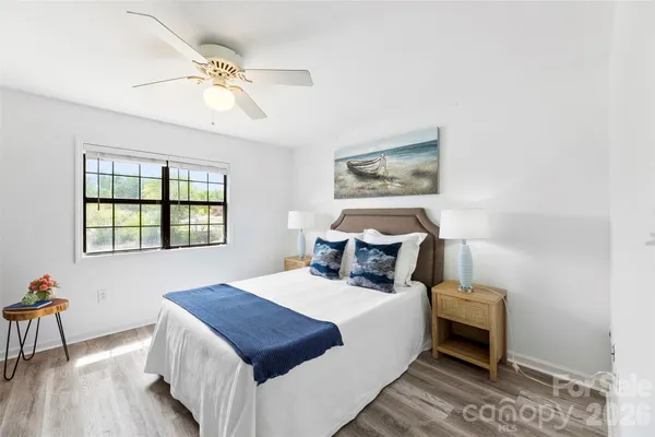 a bedroom with a bed and a chandelier