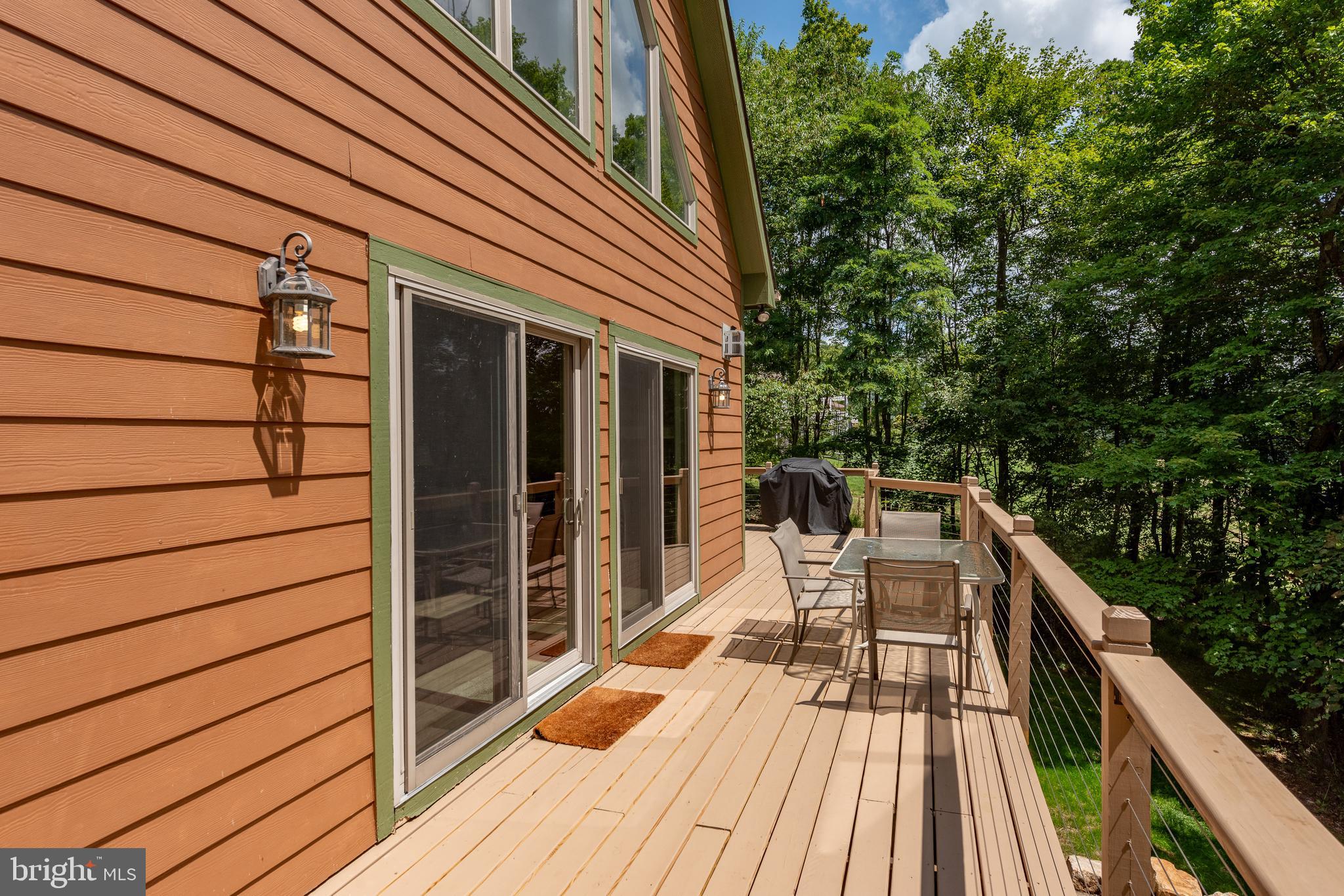 2828 Glendale Road Swanton, MD 21561 - Photo 67 of 78 a balcony with wooden floor and outdoor seating