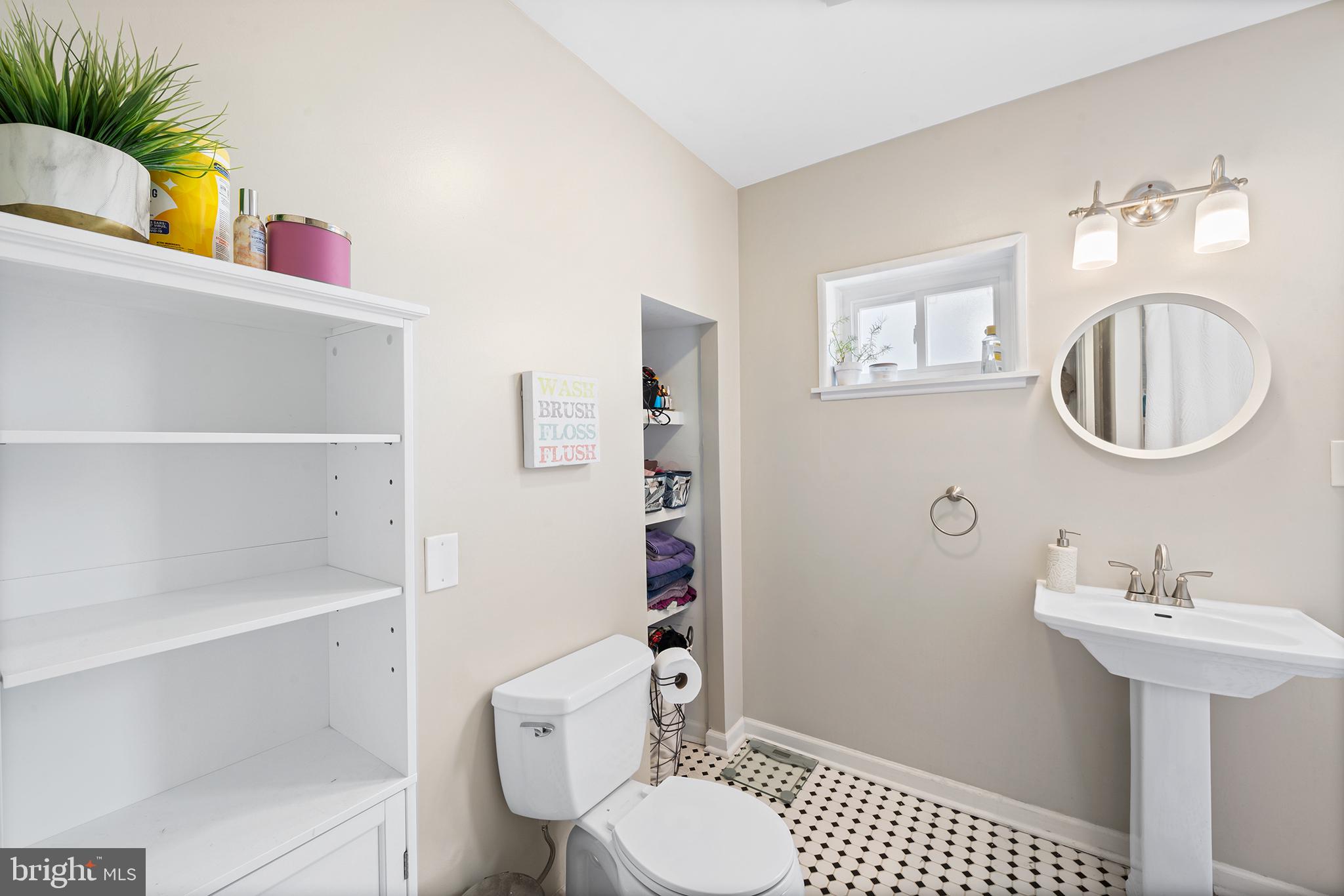 107 Master Street Philadelphia, PA 19122 - Photo 17 of 24 a bathroom with a sink a toilet and a mirror