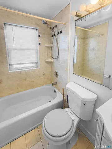 a bathroom with a toilet bathtub and shower