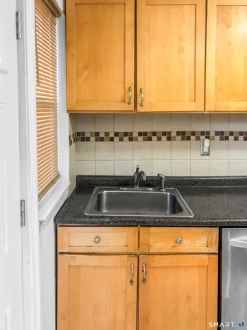 a kitchen with a sink a counter and a cabinets