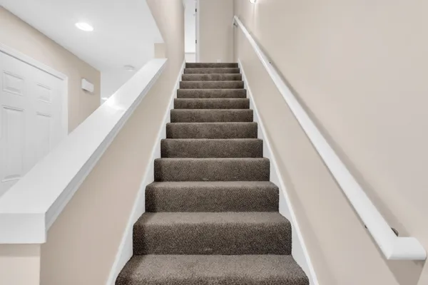 a view of staircase with wooden floor