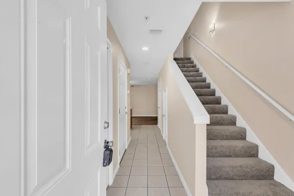 a view of staircase with white walls