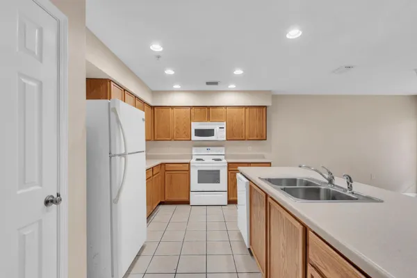 a kitchen with stainless steel appliances granite countertop a refrigerator and a sink