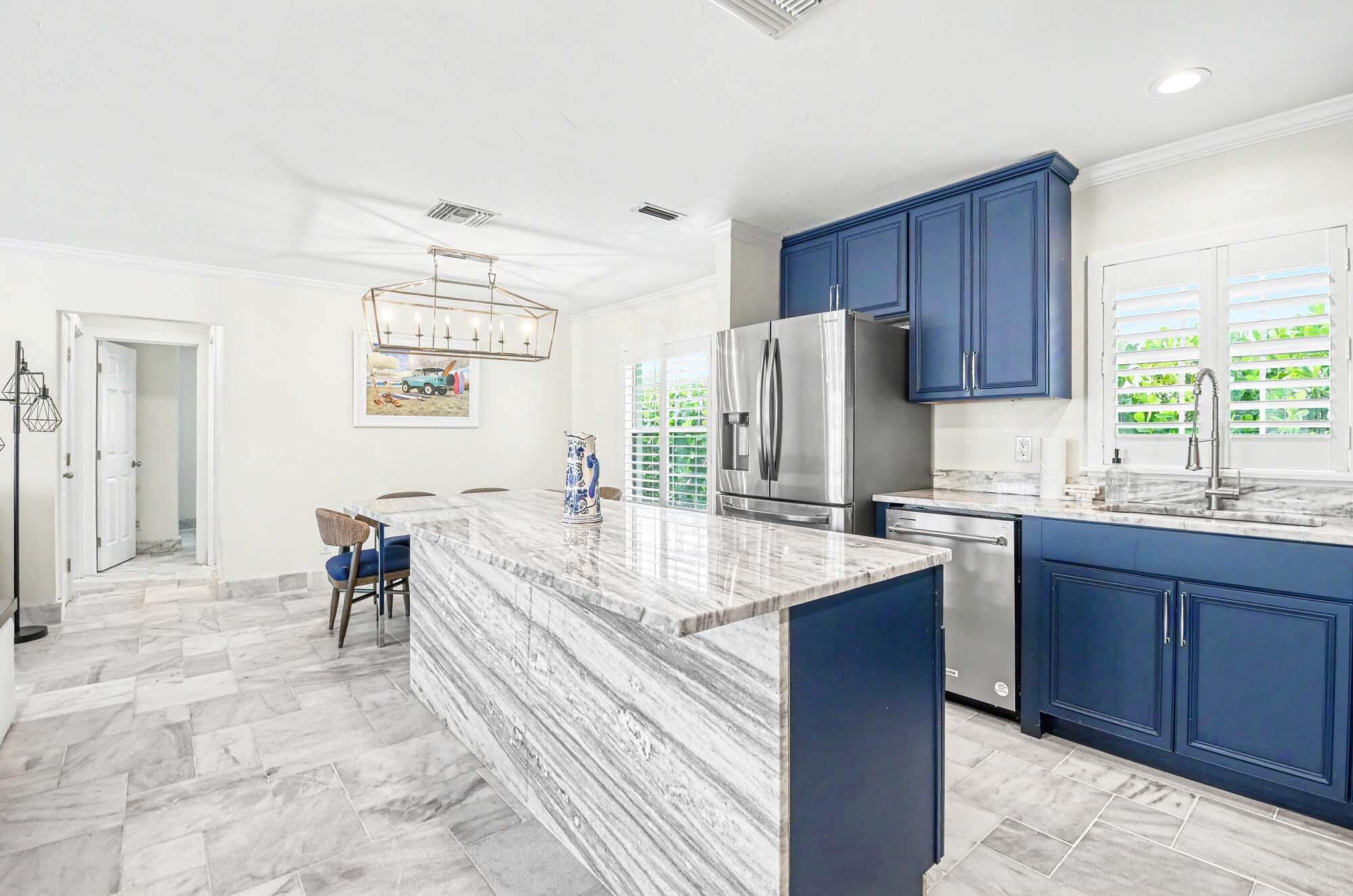 112 Capri Boulevard Naples, FL 34113 - Photo 9 of 29 a kitchen with a sink refrigerator and cabinets