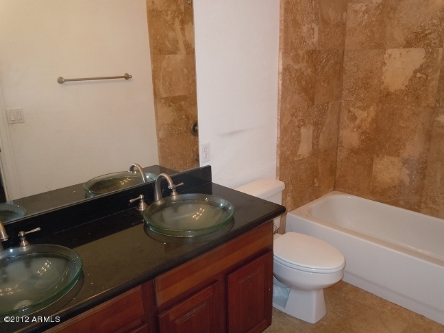 435 South Neuman Way Chandler, AZ 85225 - Photo 12 of 28 a bathroom with a granite countertop sink a toilet and bathtub