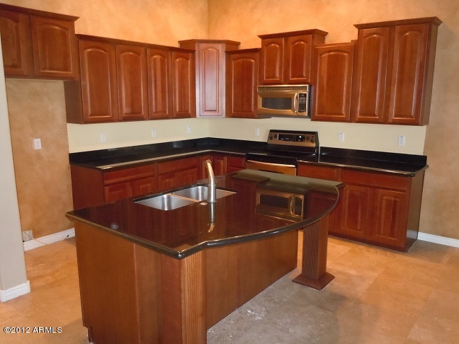 435 South Neuman Way Chandler, AZ 85225 - Photo 6 of 28 a kitchen with granite countertop cabinets and black appliances