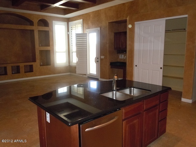 435 South Neuman Way Chandler, AZ 85225 - Photo 8 of 28 a kitchen with granite countertop a sink and a wooden cabinets