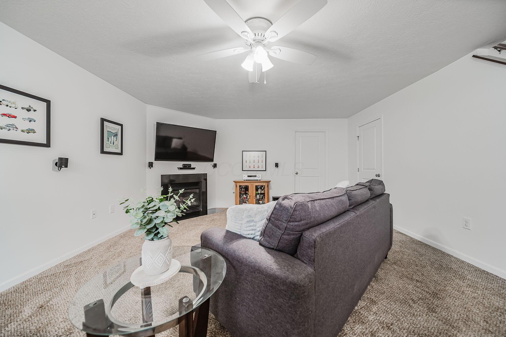 6186 Needletail Road, Unit 66 Columbus, OH 43230 - Photo 25 of 48 Finished lower level with daylight window, neutral decor, overhead lighting, and a cozy gas fireplace make this a beautiful area to spend quality time in for work and play!