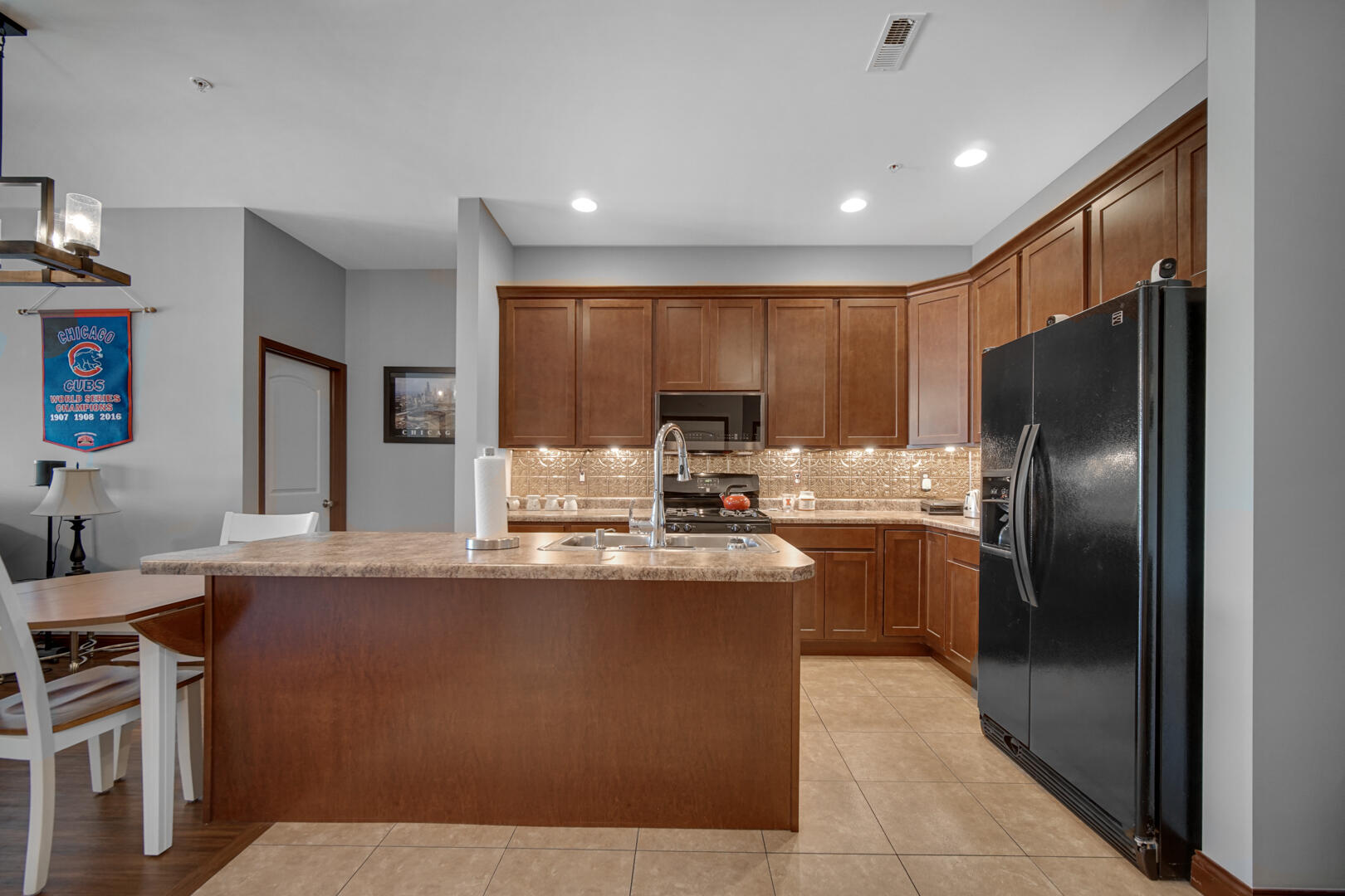 123 North Main Street, Unit 301 Crown Point, IN 46307 - Photo 11 of 25 a kitchen with stainless steel appliances granite countertop a sink stove and refrigerator