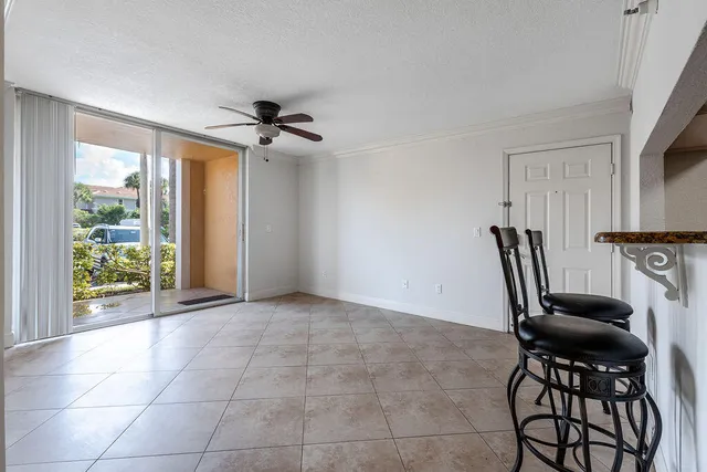 a view of a livingroom with furniture and a ceiling fan