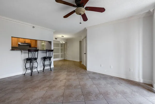 a view of a livingroom with furniture and a ceiling fan