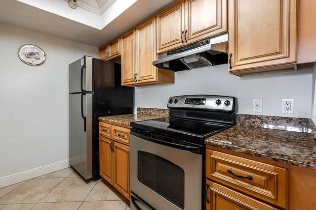 a kitchen with stainless steel appliances granite countertop a stove and a microwave
