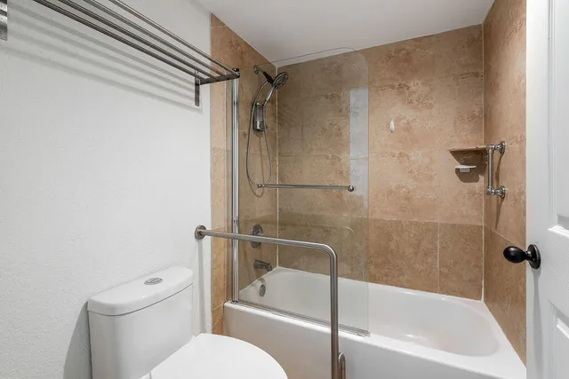 a white bath tub sitting next to a toilet