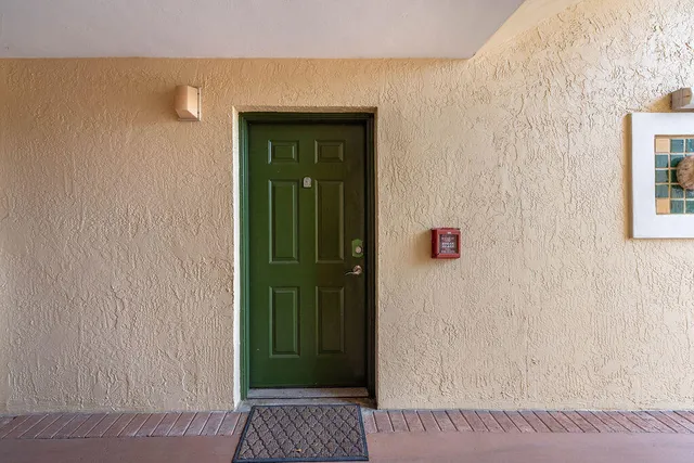 a bathroom with a shower and a wooden door