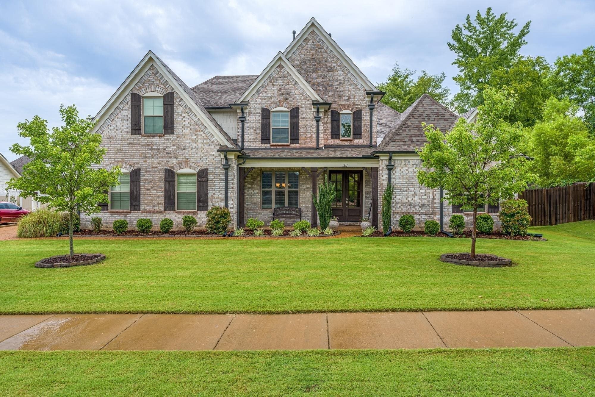 1217 Pilgrim Ridge Road Collierville, TN 38017 - Photo 1 of 33 View of front of home featuring a porch, brick siding, and roof with shingles
