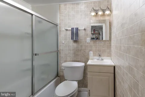 a bathroom with a toilet sink and shower