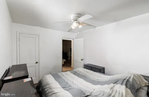 a bedroom with a bed and a chair