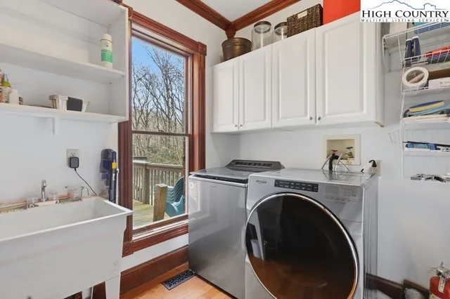 a utility room with sink dryer and washer