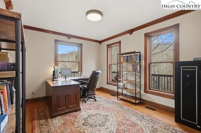 a view of a workspace with furniture and a window