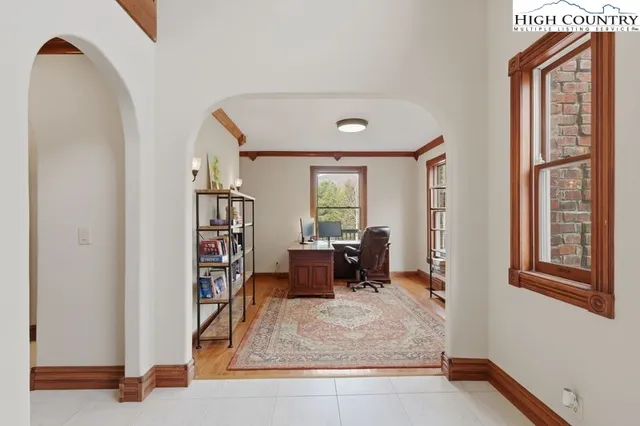 a living room with furniture and a book shelf