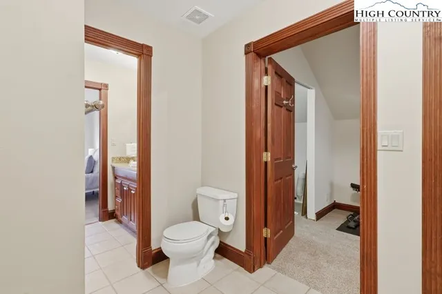 a bathroom view of a toilet and a shower