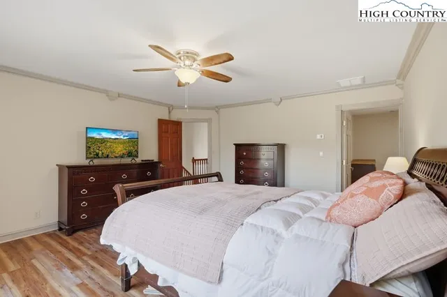 a bedroom with a bed and a chandelier