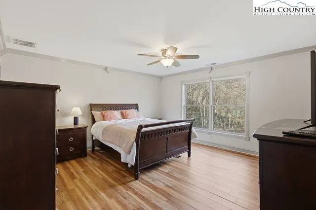 a spacious bedroom with a bed and a window