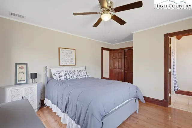 a bedroom with a large bed and a chandelier