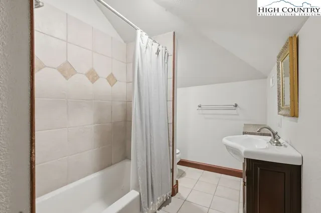 a bathroom with a sink a mirror and a bathtub