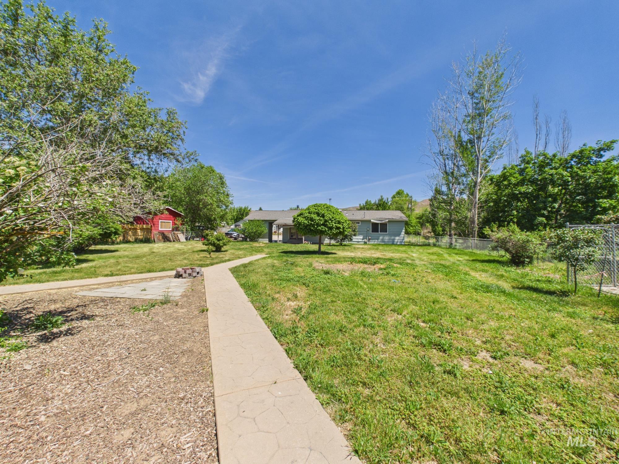1527 North Plaza Road Emmett, ID 83617 - Photo 32 of 33 Expansive front yard with a concrete pathway leading to the residence