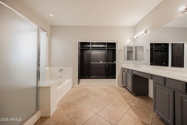 a bathroom with a tub shower and sink