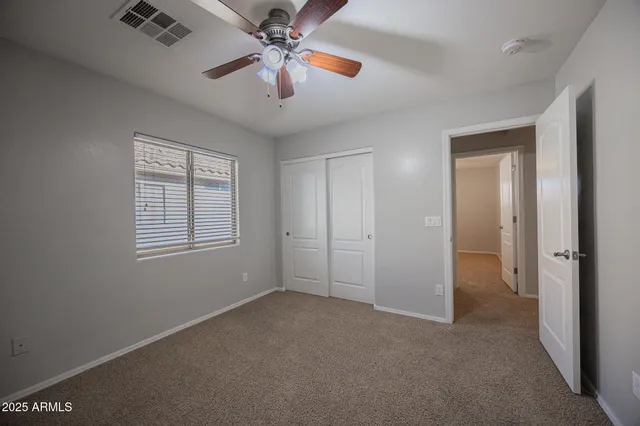 a view of a room with a ceiling fan and a window